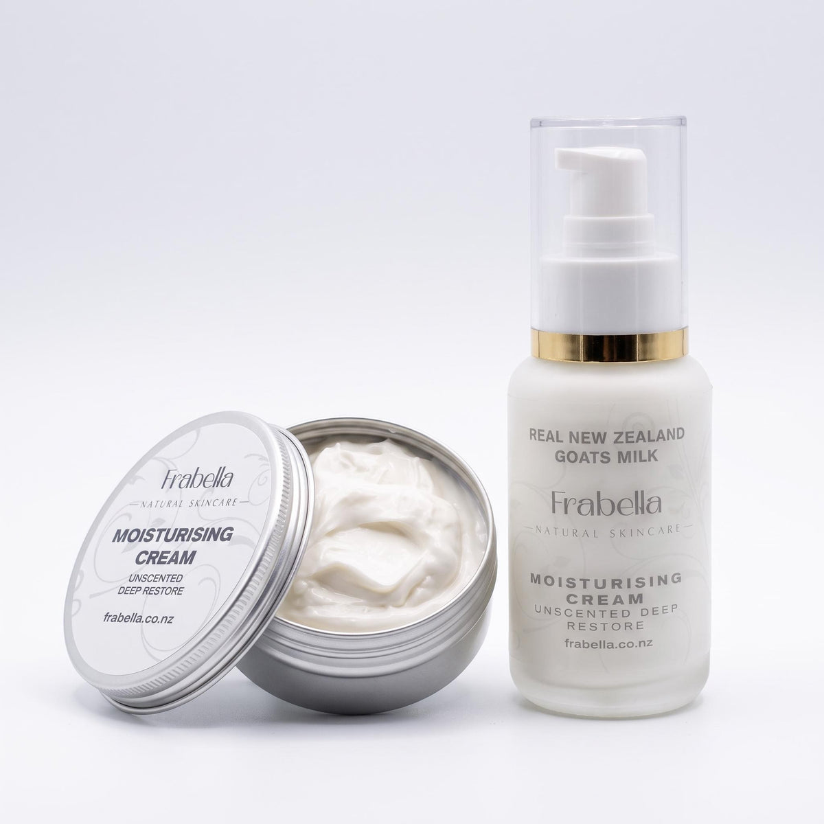 Frabella Unscented Deep Restore Moisturising Cream shown with an open silver tin containing white cream next to a white pump bottle with a gold collar and clear cap on a light gray background.