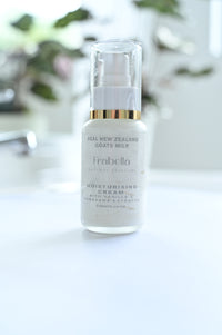 A pump bottle of moisturizing cream with the brand name 'Frobelia' displayed on it, set against a blurred background.